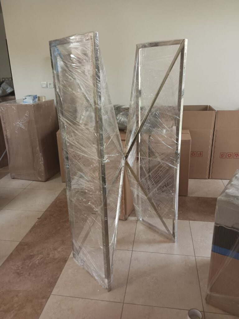 Cheap movers in Sharjah loading furniture into moving truck